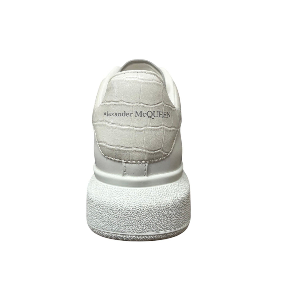 Luxury Chef white leather Alexander McQueen sneakers with embossed crocodile effect heel tab and chunky sole.