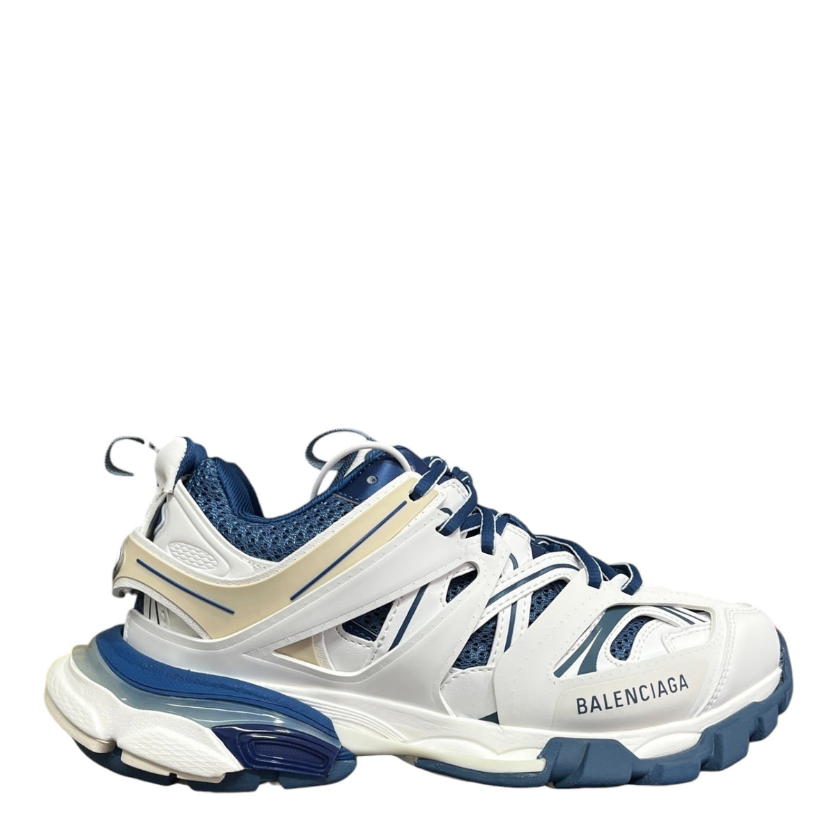 Luxury Chef BALENCIAGA Track sneakers in white, blue, and beige with mesh panels and chunky sole.
