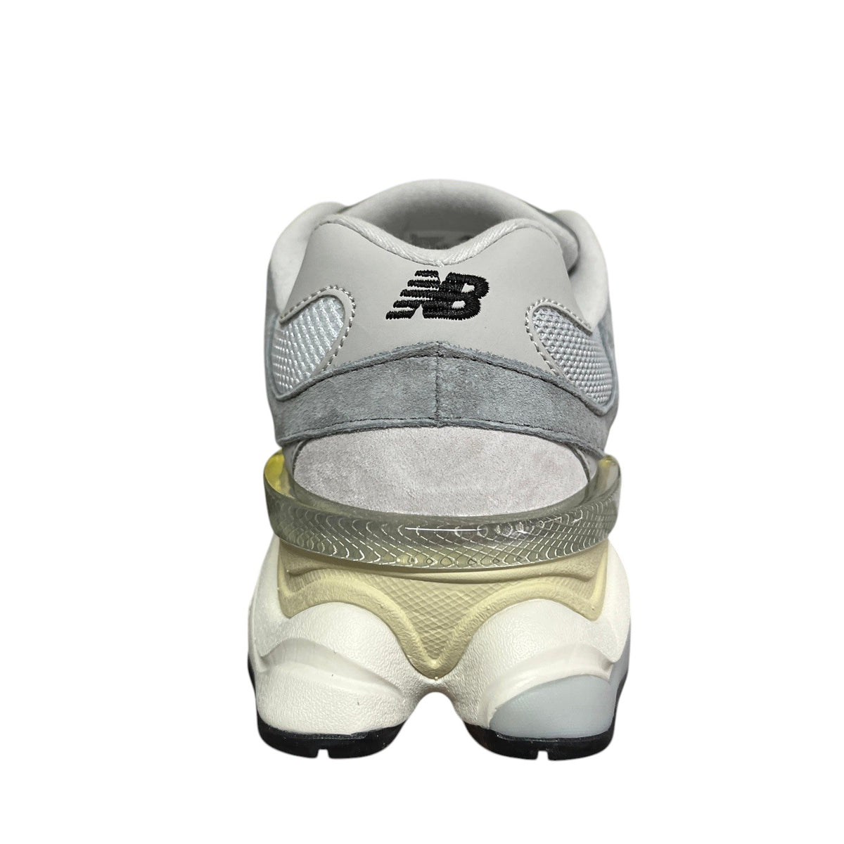 Luxury Chef New Balance 9060 grey suede and mesh sneakers with a translucent heel accent.