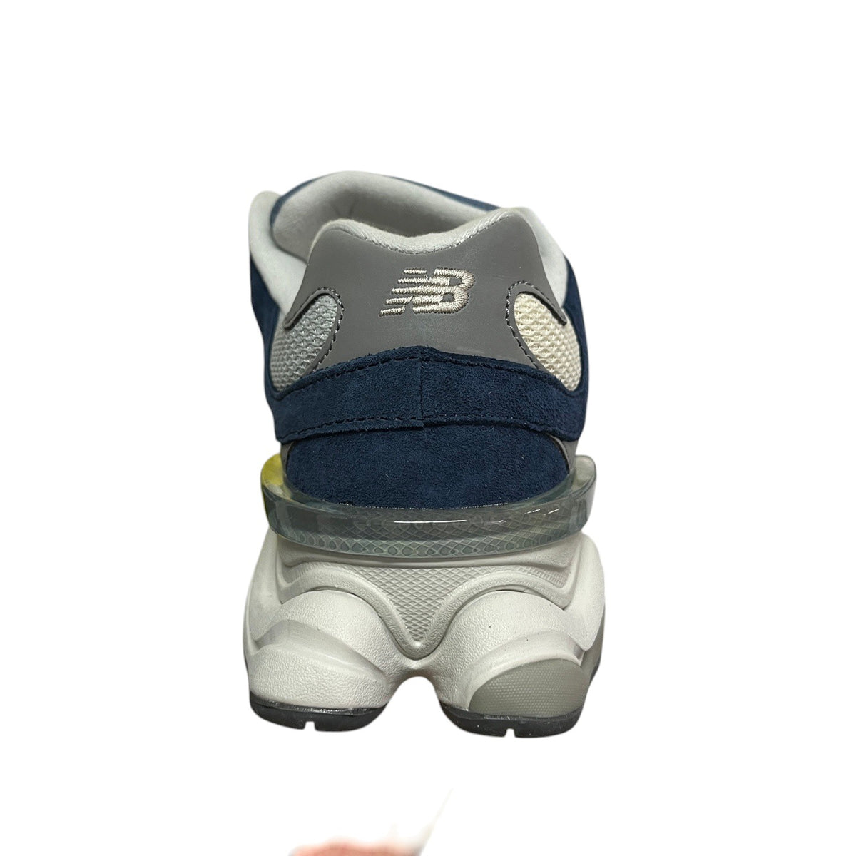Luxury Chef New Balance 9060 navy blue suede and mesh sneakers with grey accents and a chunky white sole.
