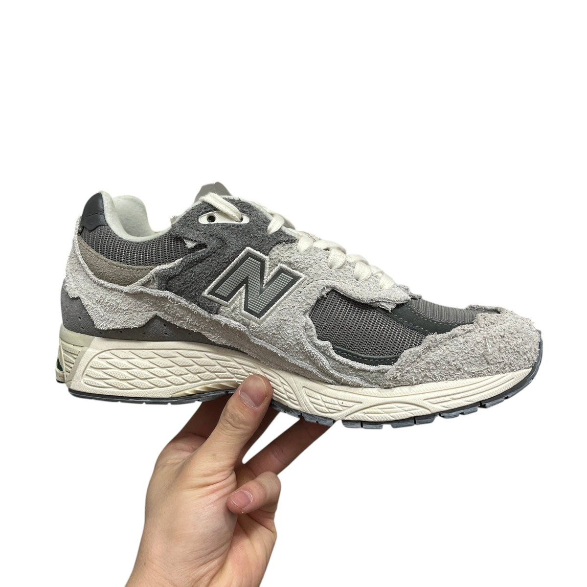 Luxury Chef New Balance 2002R sneakers in grey suede and mesh with distressed detailing.