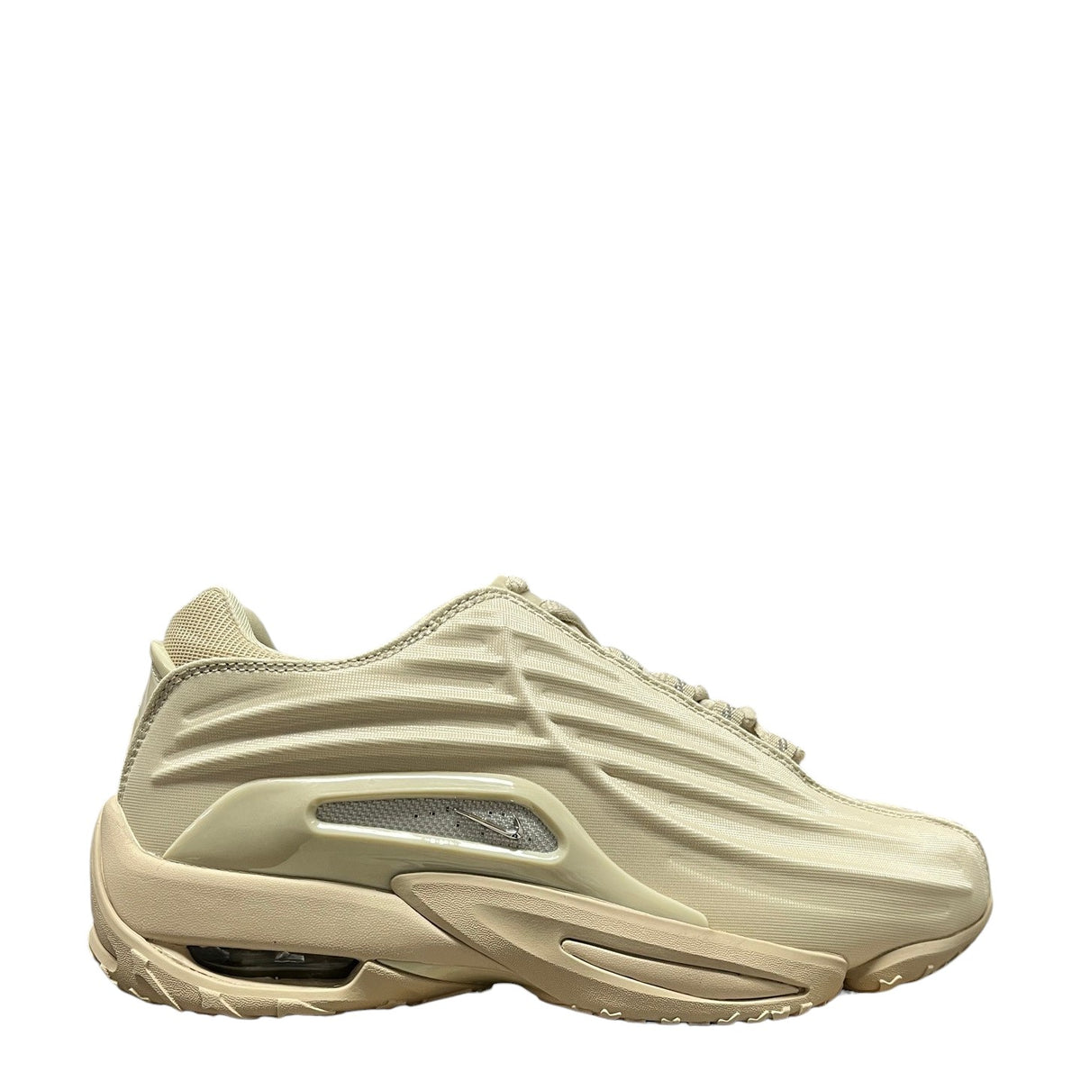 Luxury Chef NOCTA Hot Step II beige sneakers with ribbed detailing and visible air cushioning. Textile upper.